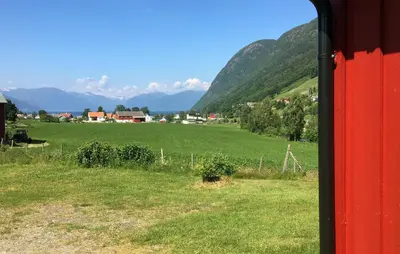 a view of a green field from a train window at 1 Bedroom Awesome Home In Vik I Sogn in Vikøyri