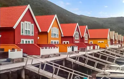 a row of houses with red roofs and a marina at 3 Bedroom Awesome Home In Gursken in Larsnes