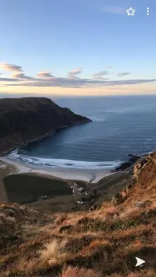 a view of the ocean from a hill with a beach at Seljesanden Apartment in Selje