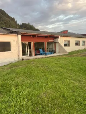 a house with a lawn in front of it at Seljesanden Apartment in Selje