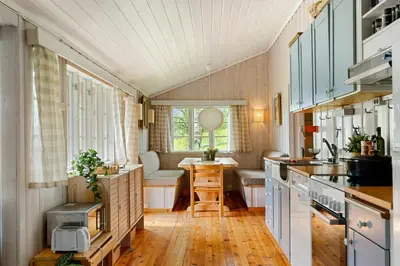 a tiny kitchen with a table and a couch at Mountain Base For Active Explorers in Oppdal