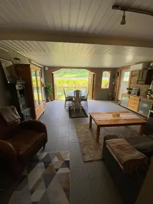 a living room with a table and a couch at Sea Front Olden in Olden