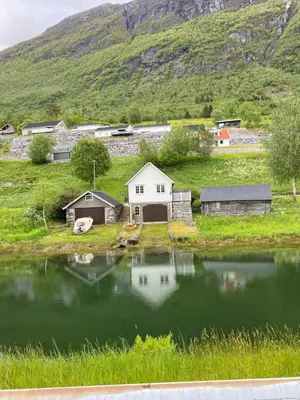 a small village with a house and a lake at Sea Front Olden in Olden