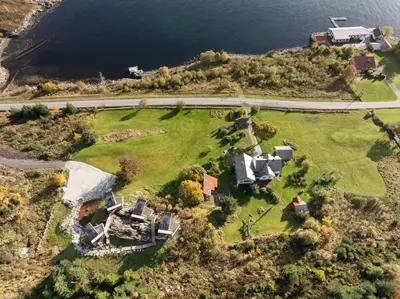 an aerial view of a house and the water at Torvika Seaview Pods in Bølandet
