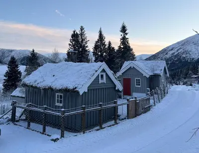 a couple of small buildings in the snow at Cozy chair in Jølster in Skei