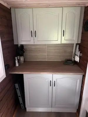 a kitchen with white cabinets and a counter at Cozy chair in Jølster in Skei