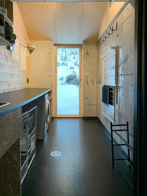 a kitchen with a counter and a large window at Unique, Modern Cabin With A Stunning View in Sogndal