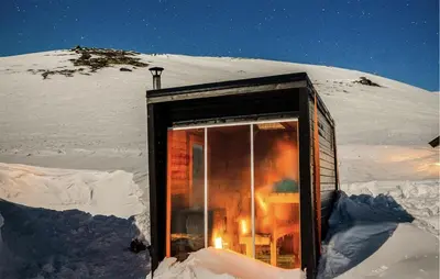 a small cabin in the snow with a window at Gorgeous Home In Vøringsfoss With Sauna in Maurset
