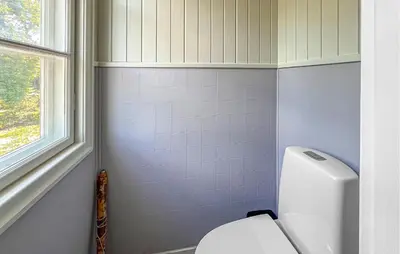 a bathroom with a white toilet and a window at Lovely Apartment In Lillehammer in Lillehammer