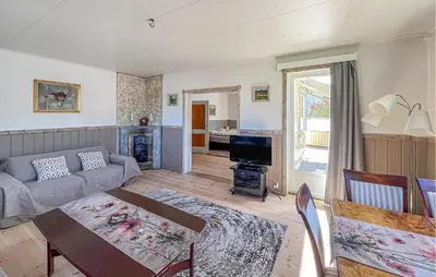 a living room with a couch and a table at Lovely Apartment In Lillehammer in Lillehammer