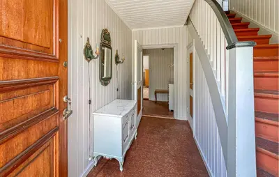 a hallway with a staircase and a door and a room at Lovely Apartment In Lillehammer in Lillehammer