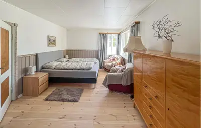 a bedroom with a bed and a dresser at Lovely Apartment In Lillehammer in Lillehammer