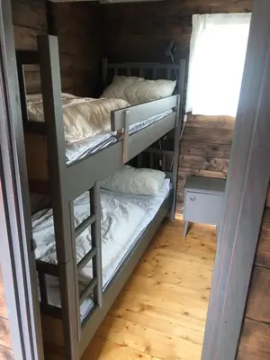a bedroom with bunk beds in a cabin at Syndinstøga in Ryfoss