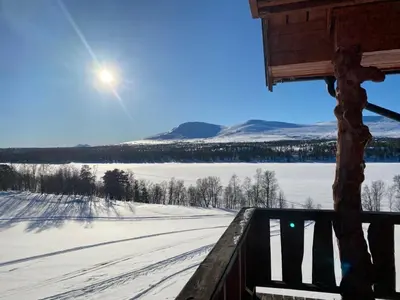 a view of a snowy field with the sun in the sky at Huset Utsikten på Langsjøvolden gård in Tolga