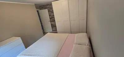 a small bedroom with a bed and a closet at Modern house in Bergen