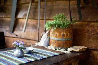 a table with a pot of flowers and a vase at Unique Cabin Between Fjord, Waterfall And Mountain in Suldalsosen