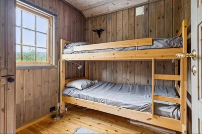 a bedroom with two bunk beds in a cabin at Guest favorite - 5 mins from Vøringsfossen in Garden