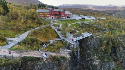 a building on the side of a mountain with a bridge at Guest favorite - 5 mins from Vøringsfossen in Garden