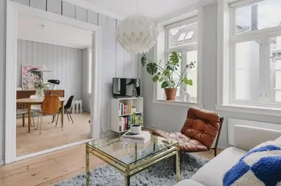 a living room with a glass table and a couch at Central apartment with 2 bedrooms in Bergen