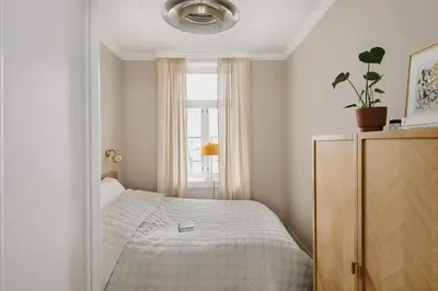 a small bedroom with a bed and a window at Central apartment with 2 bedrooms in Bergen