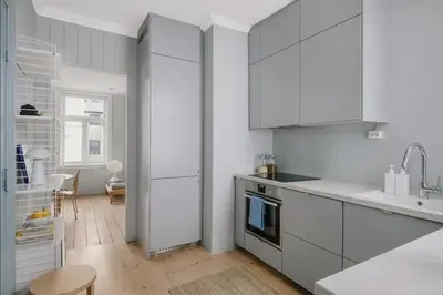 a white kitchen with white cabinets and a sink at Central apartment with 2 bedrooms in Bergen