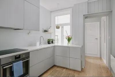 a white kitchen with a sink and a stove at Central apartment with 2 bedrooms in Bergen