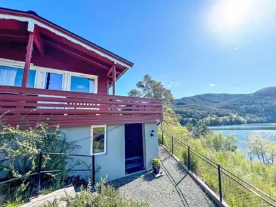 a house on the side of a river at Holiday Home Tussebu by Interhome in Gripne