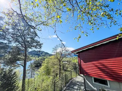 a red roofed building with a view of a river at Holiday Home Tussebu by Interhome in Gripne