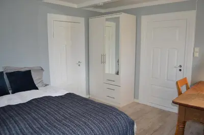 a bedroom with a bed and a desk and a table at Charming farmhouse with jacuzzi and patio in Stryn