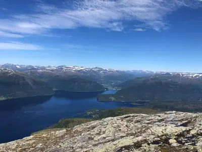 a view of a lake from the top of a mountain at Charming farmhouse with jacuzzi and patio in Stryn