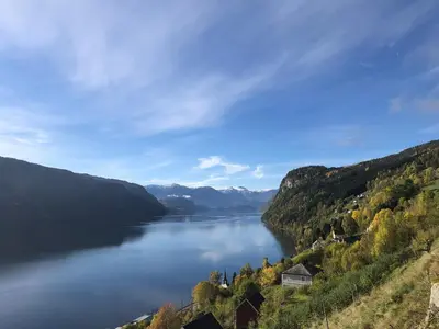 a view of a lake in the hills at Charming farmhouse with jacuzzi and patio in Stryn