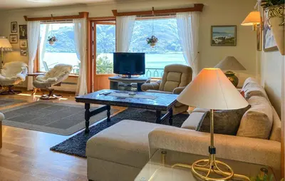 a living room with a couch and a table at Stunning Apartment In Selje With Wifi in Selje