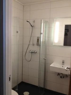 a bathroom with a shower and a sink at Haukeli Hotel in Haukeligrend