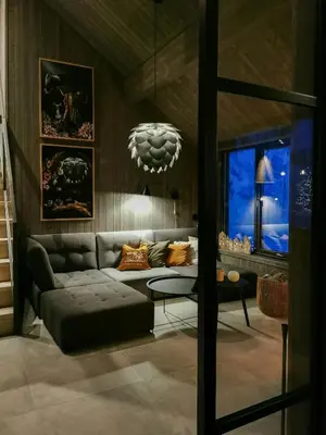 a living room with a couch and a chandelier at Family Cabin With Annexe In Haglebu in Eggedal