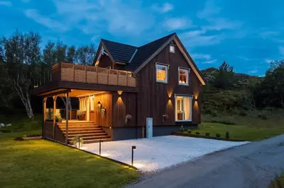 a wooden house with a gambrel roof at Kvitsand Ocean Castle in Hitra