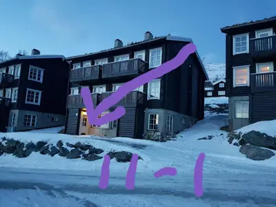 a building with a purple x sign in the snow at Fjellleilighet med drømmeutsikt in Oppdal