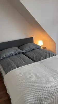 a bed with two pillows on it in a room at Hyggehuset in Bergen