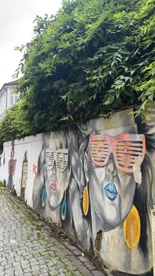 a wall with a painting of faces with sunglasses at Hyggehuset in Bergen