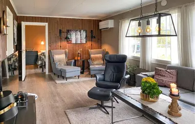 a living room with a chair and a couch at Stunning Home In Bjorli With Wifi in Bjorli
