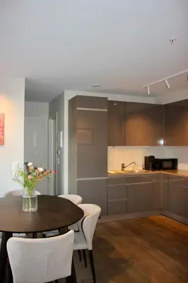 a kitchen and dining room with a table and chairs at Central apartment in Bergen
