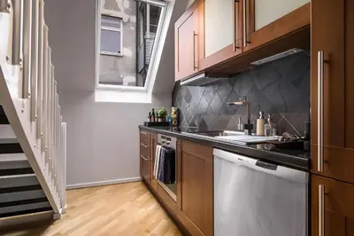 a kitchen with a sink and a dishwasher at Bright Top-Floor Apartment with Sea View in Bergen