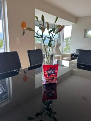 a vase with flowers in it sitting on a table at Husafjellet in Ålesund
