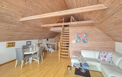 a living room with a couch and a staircase at Nice Home In Manger With House Sea View in Manger