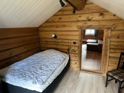 a bedroom with a bed in a wooden cabin at Lekker tømmerhytte in Tyinkrysset