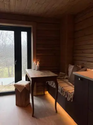 a room with a bed and a table with candles at Timber Cabin By The Ski Slopes In Oppdal in Oppdal