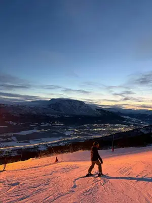 a person is skiing down a snow covered slope at Timber Cabin By The Ski Slopes In Oppdal in Oppdal
