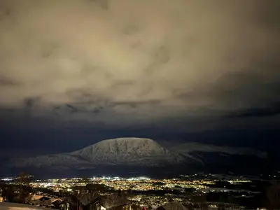 a view of a snow covered mountain at night at Timber Cabin By The Ski Slopes In Oppdal in Oppdal