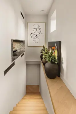 a hallway with a staircase with a plant in a vase at Exclusive Villa - Scandinavian Luxury At Its Best in Bergen