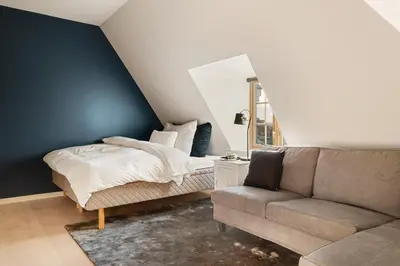 a bedroom with a bed and a couch at Exclusive Villa - Scandinavian Luxury At Its Best in Bergen