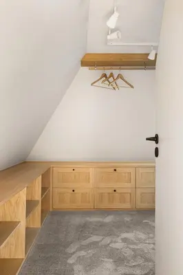 a room with wooden cabinets and a white wall at Exclusive Villa - Scandinavian Luxury At Its Best in Bergen